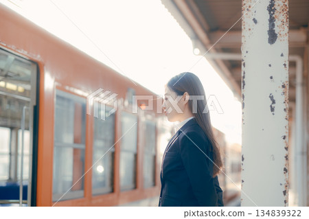Japanese female university student waiting for a train on the station platform 134839322