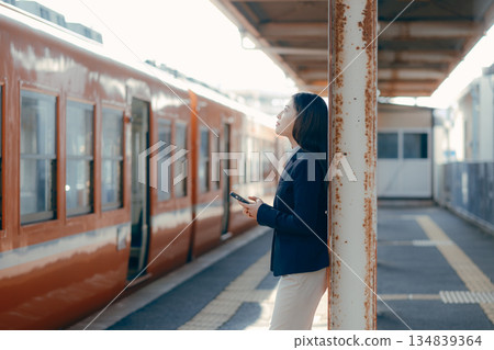一名日本女大學生正在用智慧型手機通話 一名日本女大學生正在用智慧型手機通話 134839364