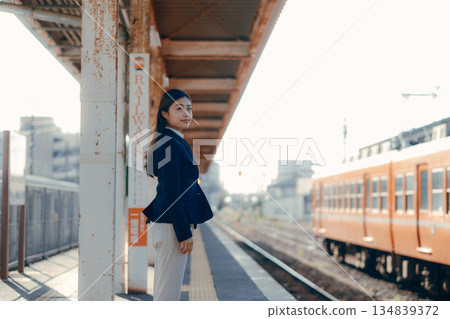 Japanese female university student standing on the station platform 134839372