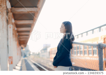 Japanese female university student standing on the station platform Japanese female university student standing on the station platform 134839375