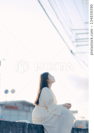 Japanese female university student standing on the street Japanese female university student standing on the street 134839390