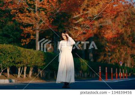 Japanese woman standing in an autumn park 134839456