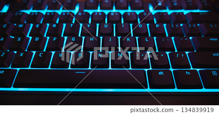 Backlit Gaming Keyboard with Cyan Blue LED Light Close-up. High quality photo Backlit Gaming Keyboard with Cyan Blue LED Light Close-up. High quality photo 134839919