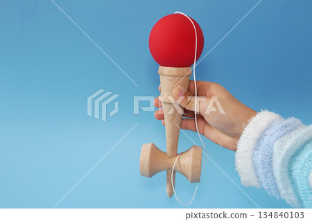 Child's hands playing Kendama 02 134840103