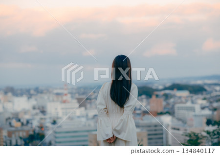 A Japanese woman standing with the cityscape in the background A Japanese woman standing with the cityscape in the background 134840117