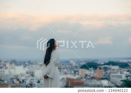 A Japanese woman standing with the cityscape in the background A Japanese woman standing with the cityscape in the background 134840122