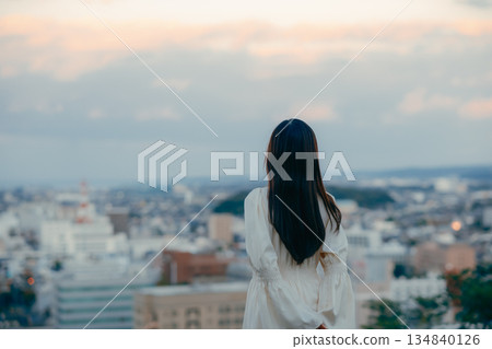 A Japanese woman standing with the cityscape in the background A Japanese woman standing with the cityscape in the background 134840126