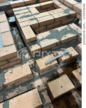 Brickwork of the stove and bench of a heating stove. Brickwork of the stove and bench of a heating stove. 134840686