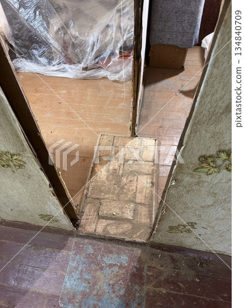 Brick base of an old heating stove between interior partitions. Brick base of an old heating stove between interior partitions. 134840709