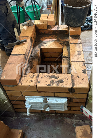 Construction of a heating stove. Fresh brickwork of the stove firebox. 134840717