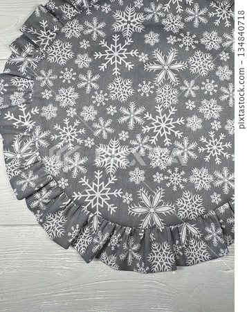 Table setting. Tableware napkin. Round with ruffles. On white boards. Winter theme, snowflake print. Shot from above. Table setting. Tableware napkin. Round with ruffles. On white boards. Winter theme, snowflake print. Shot from above. 134840718