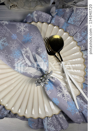Table setting. Cutlery and napkins. Winter theme. Shot from above. Table setting. Cutlery and napkins. Winter theme. Shot from above. 134840720