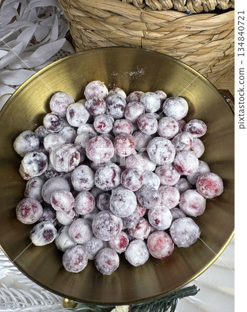 Cranberries in sugar. In a golden cup. Shot from above. Close-up. Cranberries in sugar. In a golden cup. Shot from above. Close-up. 134840721
