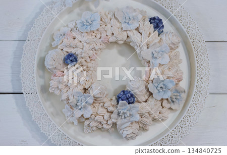 Marshmallow wreath. Wreath made of marshmallow flowers. On a tray. Shot from above Marshmallow wreath. Wreath made of marshmallow flowers. On a tray. Shot from above 134840725