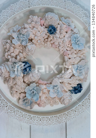Marshmallow wreath. Wreath made of marshmallow flowers. On a tray. Shot from above. Marshmallow wreath. Wreath made of marshmallow flowers. On a tray. Shot from above. 134840726
