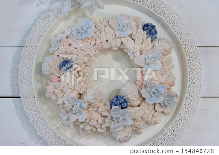 Marshmallow wreath. Wreath made of marshmallow flowers. Shot from above. Marshmallow wreath. Wreath made of marshmallow flowers. Shot from above. 134840728
