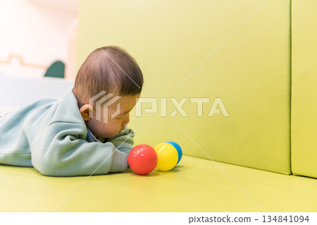 A Japanese baby boy playing in the kids' room of an apartment building 134841094