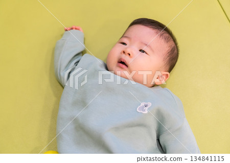 A Japanese baby boy playing in the kids' room of an apartment building A Japanese baby boy playing in the kids' room of an apartment building 134841115