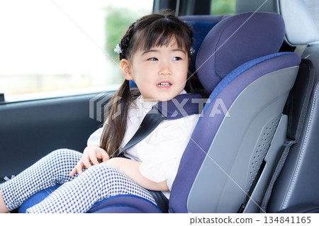 Girl sitting in a child seat 134841165