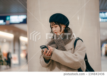 一位三十多歲的女性在等待預約時使用智慧型手機 134841436