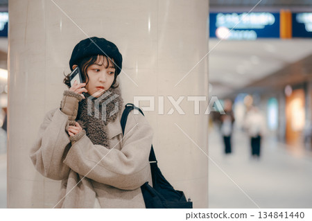 A woman in her 30s using a smartphone while waiting for an appointment A woman in her 30s using a smartphone while waiting for an appointment 134841440