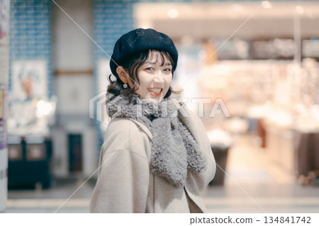 Smiling portrait of a woman in her 30s walking together in the city Smiling portrait of a woman in her 30s walking together in the city 134841742