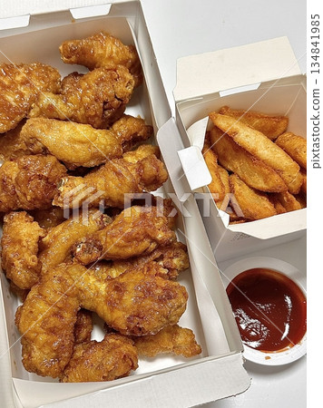 Crispy fried chicken with golden, crunchy skin and juicy, tender meat. A delicious and savory dish, perfect for any meal, served with dipping sauces or side dishes for extra flavor! 134841985