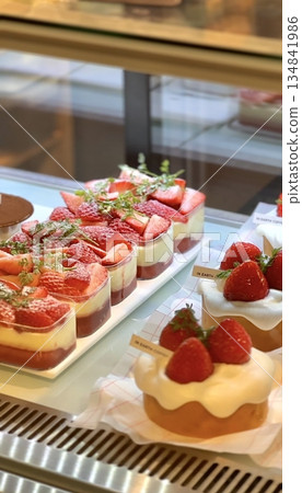 Beautiful and delicious pastries displayed in a bakery, with colorful glazes, delicate toppings, and tempting textures. Offering a perfect visual feast of sweetness and artisanal charm. 134841986