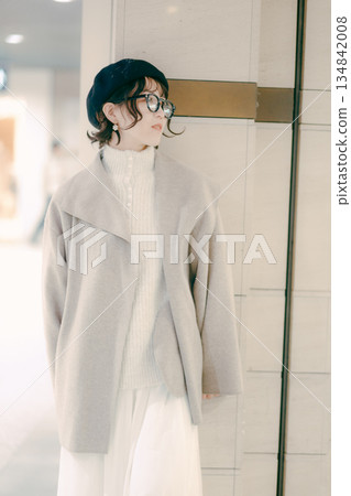 A woman in her 30s stops while waiting for an appointment 134842008