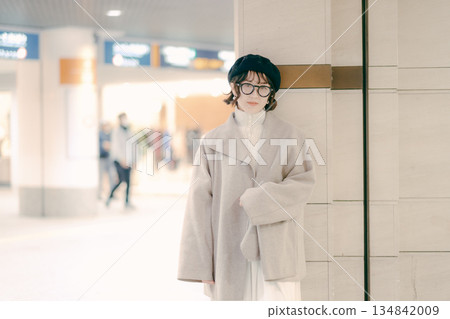 A woman in her 30s stops while waiting for an appointment 134842009