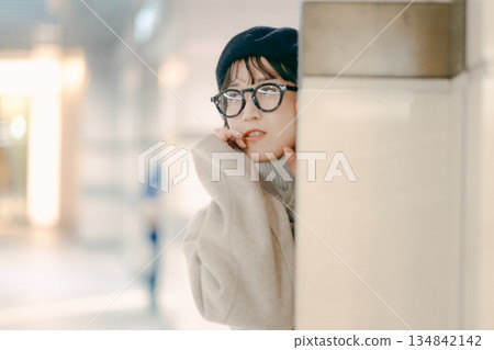 A simple portrait of a woman in her 30s standing A simple portrait of a woman in her 30s standing 134842142