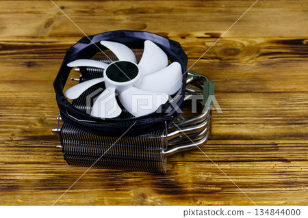 Modern CPU cooler on a wooden desk 134844000