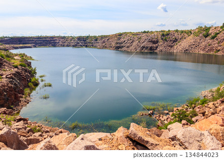 View of the lake at abandoned quarry on summer View of the lake at abandoned quarry on summer 134844023
