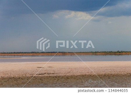 Dark storm clouds over a salt lake before a rain 134844035