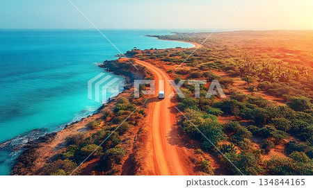 Coastal Road Trip: Van Journeys a Sunlit Desert Path Beside Turq 134844165