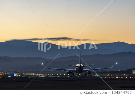 Sendai Airport at dusk, airplane taking off, Natori City, Miyagi Prefecture Sendai Airport at dusk, airplane taking off, Natori City, Miyagi Prefecture 134844793