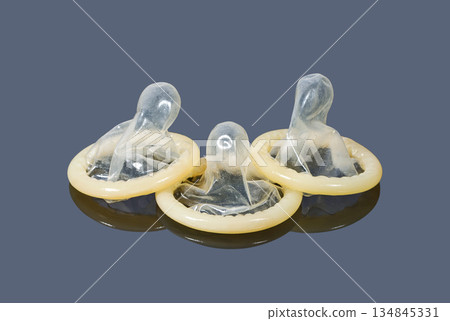 Contraception hree condoms on dark background Contraception hree condoms on dark background 134845331