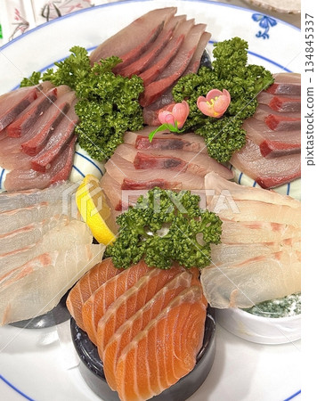 Fresh and delicate sashimi slices, beautifully presented with vibrant colors and perfect cuts. This traditional Japanese delicacy highlights the pure flavors of premium seafood. Fresh and delicate sashimi slices, beautifully presented with vibrant colors and perfect cuts. This traditional Japanese delicacy highlights the pure flavors of premium seafood. 134845337