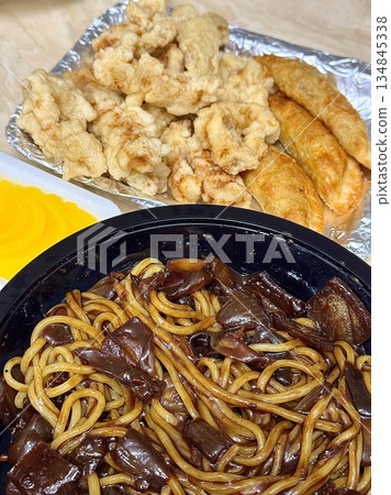 A classic Korean-Chinese combo of jajangmyeon with thick, chewy noodles coated in rich black bean sauce, served alongside crispy tangsuyuk, deep-fried pork with sweet and sour sauce. A classic Korean-Chinese combo of jajangmyeon with thick, chewy noodles coated in rich black bean sauce, served alongside crispy tangsuyuk, deep-fried pork with sweet and sour sauce. 134845338
