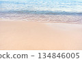 Soft blue ocean waves gently lapping onto a pristine tropical sandy beach 134846005