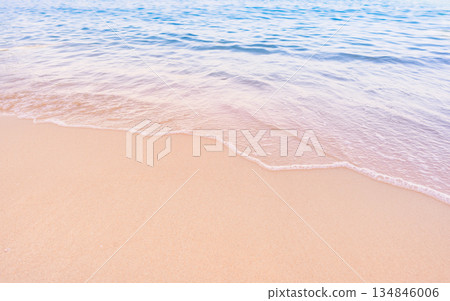 Soft blue ocean waves gently lapping onto a pristine tropical sandy beach Soft blue ocean waves gently lapping onto a pristine tropical sandy beach 134846006