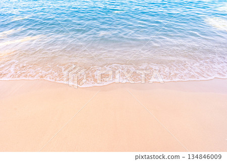 Soft blue ocean waves gently lapping onto a pristine tropical sandy beach Soft blue ocean waves gently lapping onto a pristine tropical sandy beach 134846009