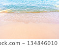 Soft blue ocean waves gently lapping onto a pristine tropical sandy beach 134846010