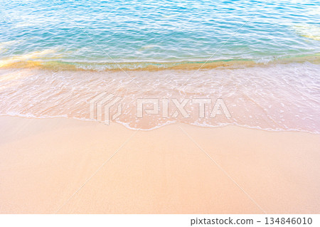 Soft blue ocean waves gently lapping onto a pristine tropical sandy beach Soft blue ocean waves gently lapping onto a pristine tropical sandy beach 134846010