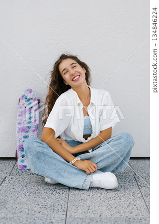 Smiling Alpha Generation Girl Sitting With Skateboard Smiling Alpha Generation Girl Sitting With Skateboard 134846224