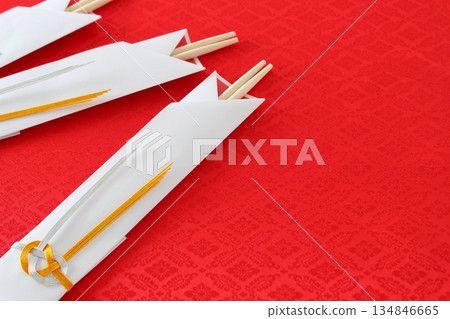 Celebration chopsticks (round chopsticks, chopstick case, Mizuhiki, gold and silver, Awaji knot) [red background, copy space, simple] 134846665