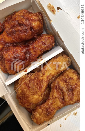 Crispy Korean fried chicken, perfectly glazed with a sweet and spicy sauce. Ideal for food photography and menus, showcasing the irresistible crunch and flavor of this beloved dish. 134846681