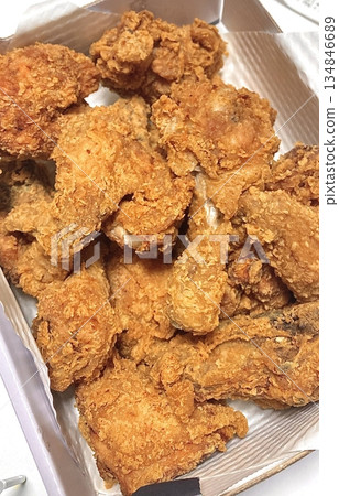 Crispy Korean fried chicken, perfectly glazed with a sweet and spicy sauce. Ideal for food photography and menus, showcasing the irresistible crunch and flavor of this beloved dish. 134846689