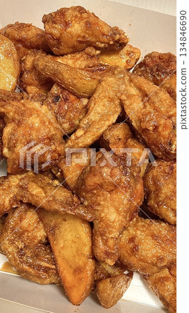 Crispy Korean fried chicken, perfectly glazed with a sweet and spicy sauce. Ideal for food photography and menus, showcasing the irresistible crunch and flavor of this beloved dish. 134846690
