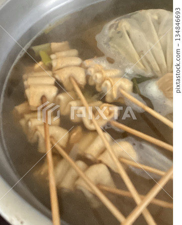 Odeng, a popular Korean street food made from seasoned fish cake, skewered and served in a warm, savory broth. Often paired with dipping sauces, it's a comforting and flavorful snack enjoyed anytime. 134846693